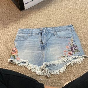 High rise jean shorts with flowers on the side.